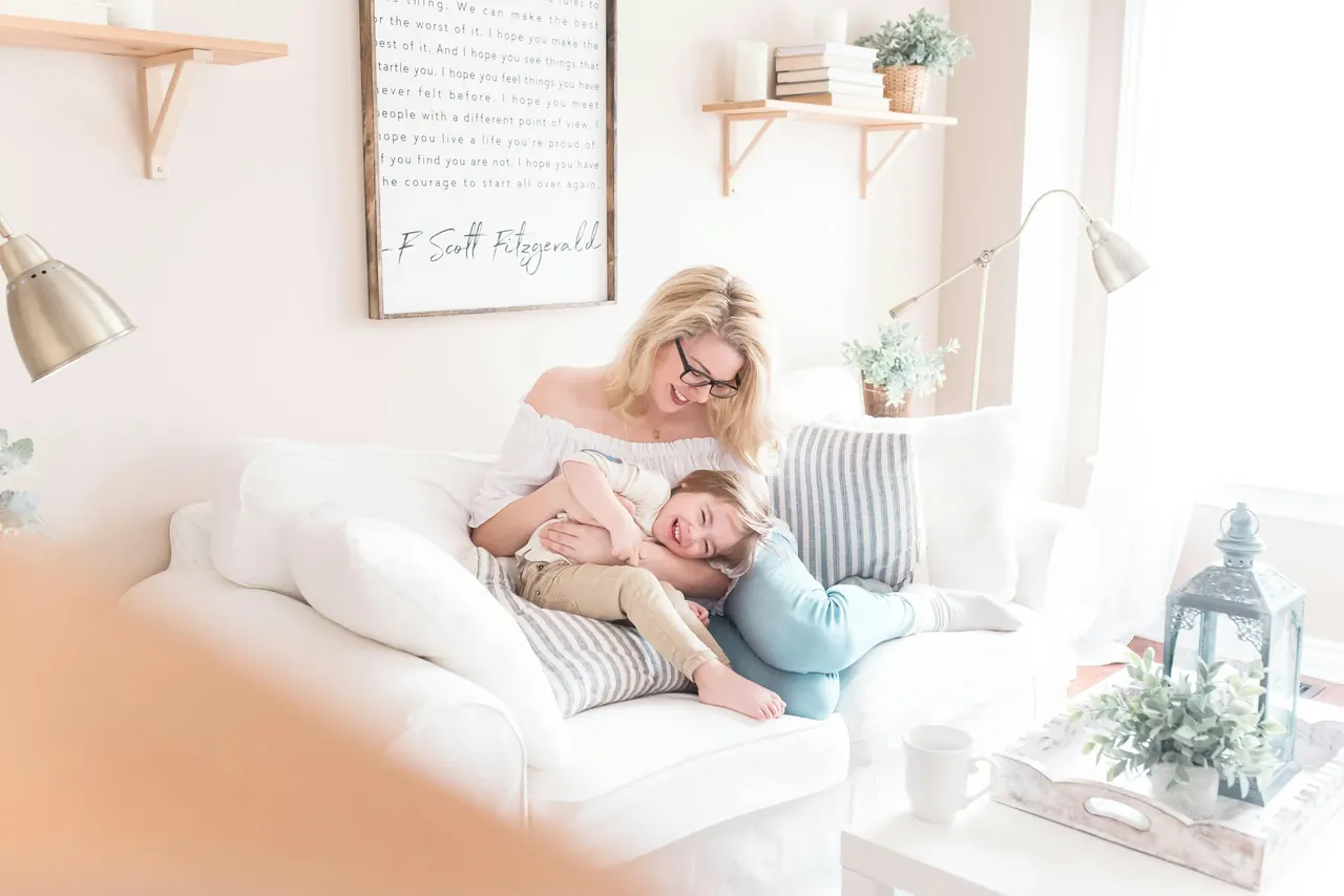 Mère et enfant détendus sur un canapé dans un intérieur clair